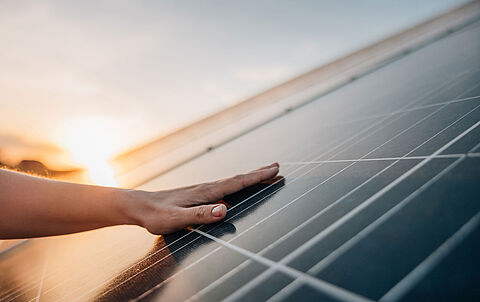 Hand berührt Photovoltaikmodul
