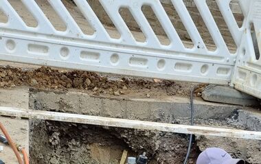 Das Bild zeigt einen e-netz-Monteur in einem Graben nach der Flutkatastrophe in Walporzheim.